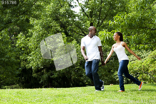 Image of Happy couple running in park