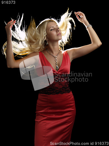 Image of Hot blonde in red dress shaking hair