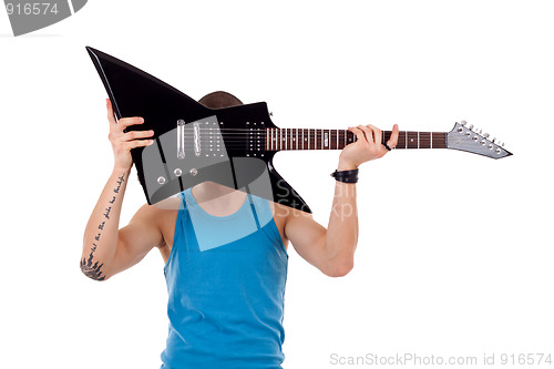 Image of player holding his guitar over face