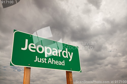 Image of Jeopardy Green Road Sign Over Storm Clouds