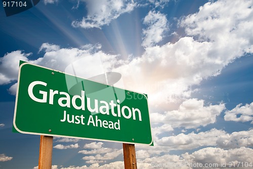Image of Graduation Green Road Sign Over Clouds