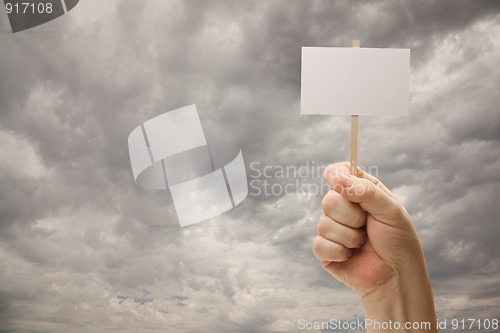 Image of Man Holding Blank Sign Over Dramatic Storm Clouds