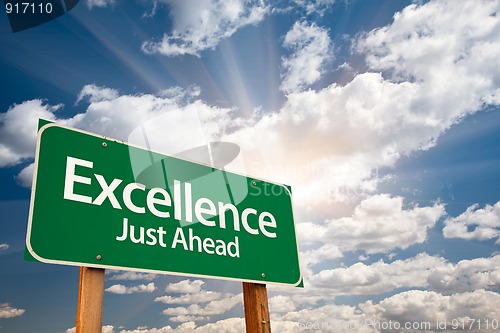 Image of Excellence Green Road Sign Over Clouds