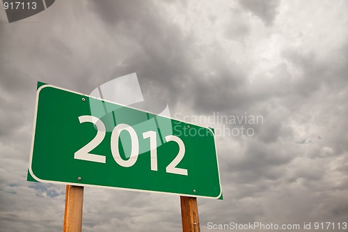 Image of 2012 Green Road Sign Over Storm Clouds