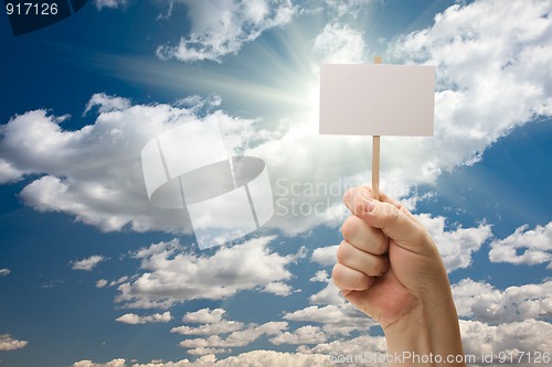 Image of Man Holding Blank Sign Over Clouds and Sky