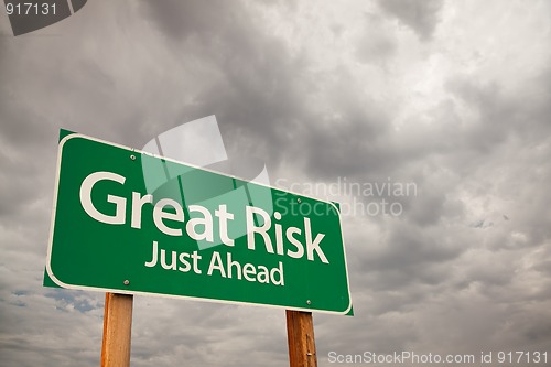 Image of Great Risk Green Road Sign Over Storm Clouds