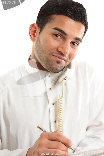 Image of Businessman on phone call with newspaper