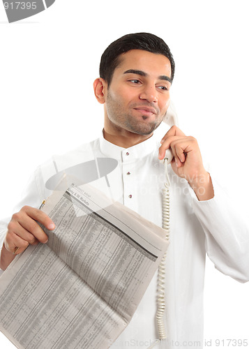 Image of Stockbroker or Businessman on phone holding newspaper