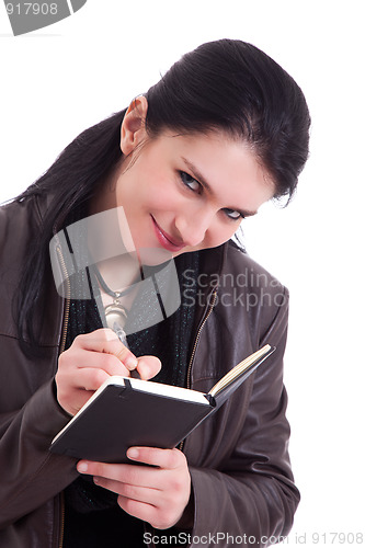 Image of beautiful businesswoman taking notes