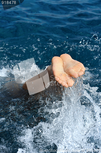 Image of Young man jumping into water