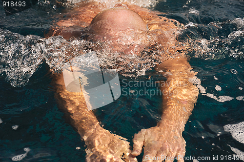 Image of Detail of young man swimming