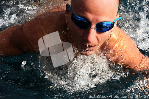 Image of Detail of young man swimming