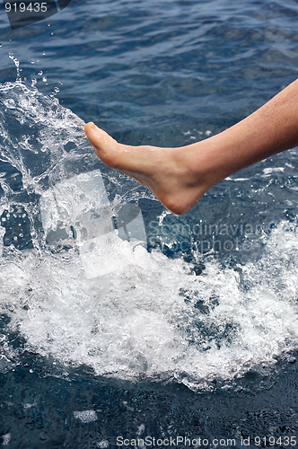 Image of Foot of young man in water - splash