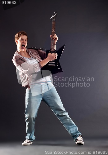 Image of passionate guitarist playing