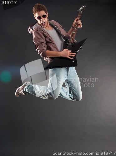 Image of passionate guitarist jumps 