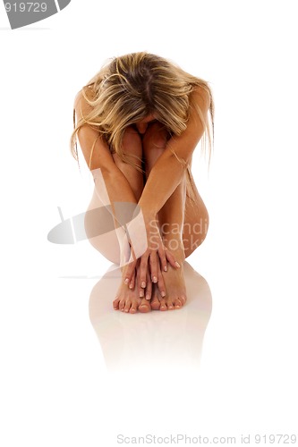 Image of woman embracing her legs