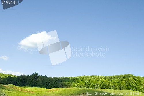 Image of countryside green hill and blue sky