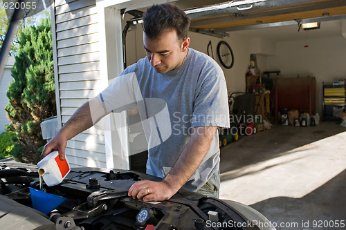 Image of Man Changing the Oil