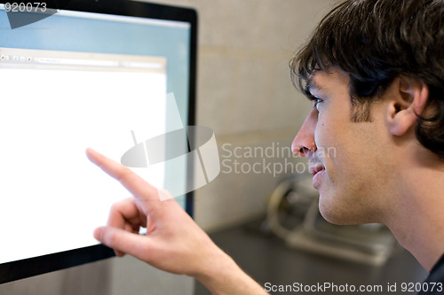 Image of Man Pointing at Computer Screen