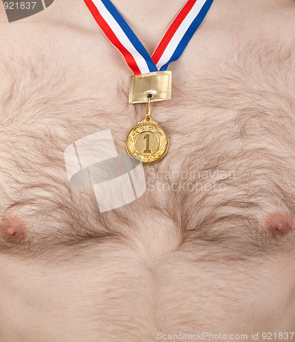 Image of Nude male thorax with hair and golden medal