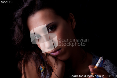 Image of Young sexy brunette with cigarette