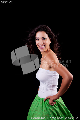 Image of young and beautiful woman smiling, with her hair in the wind