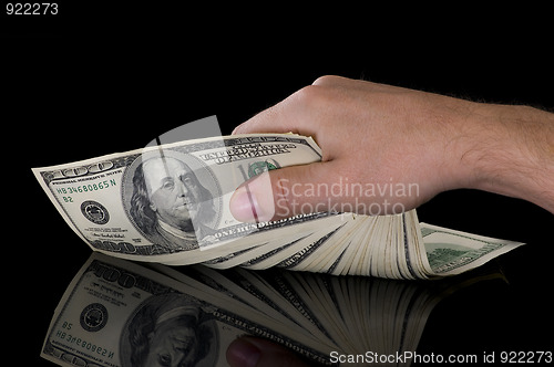 Image of hand with dollars