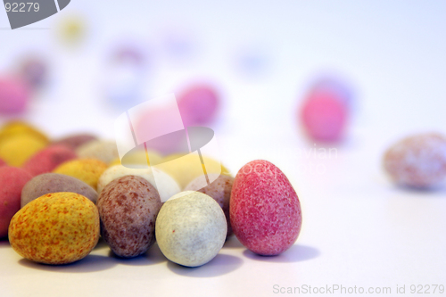 Image of Mini candy chocolate eggs on a white surface