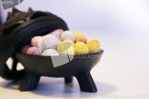 Image of Mini candy chocolate eggs in a decorative tripod dish