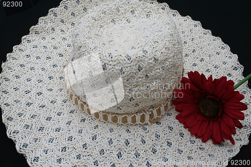 Image of White hat and red flower
