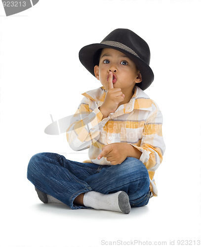 Image of cute boy with finger on his lips