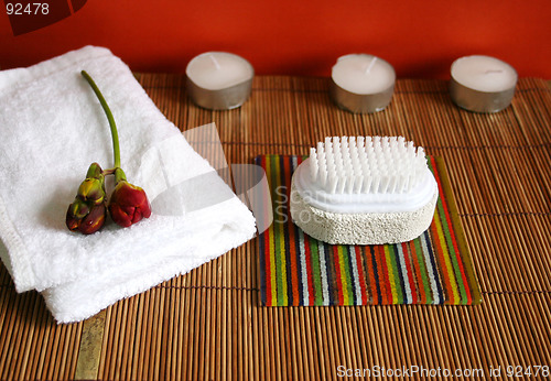 Image of Pumice brush, candles and towel at a spa - health and beauty