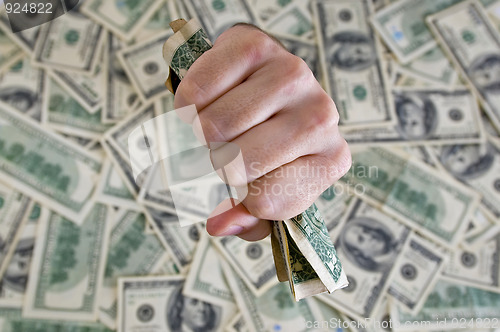 Image of fist with dollar bills