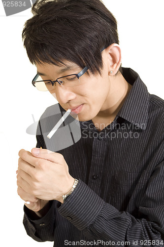 Image of Young Asian man smoking