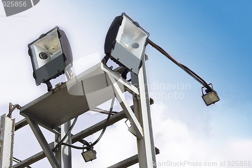 Image of stadium lights against a blue sky 