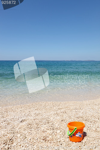 Image of beautiful beach with child's bucket