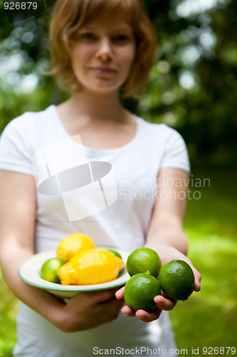Image of Girl holding a bowl of lemon and lime