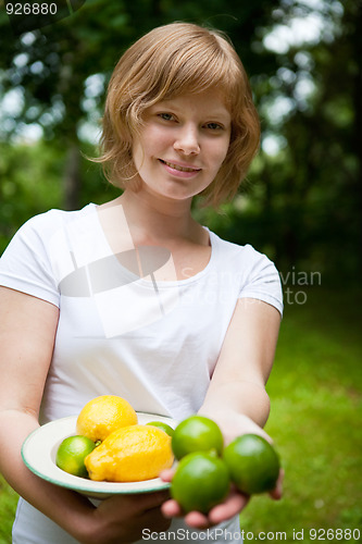 Image of Girl holding a bowl of lemon and lime