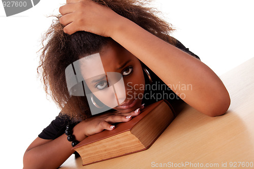 Image of woman stressed ,with her head resting upon the book