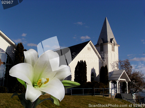 Image of easter lily blooms in front of church