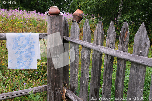 Image of Clay Pots and Towel on the Fence