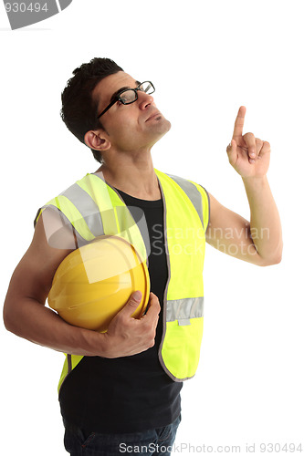 Image of Building construction worker lookin up pointing