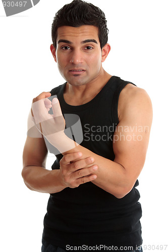 Image of Man, fitness instructor, builder nursing sore arm