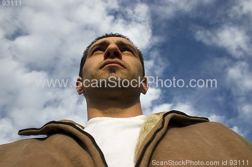 Image of Man Looking up with the Clouds on the Background