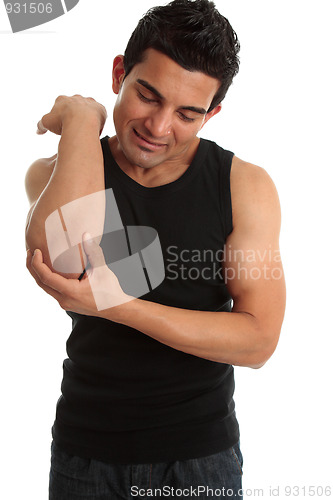 Image of Man with injury wincing