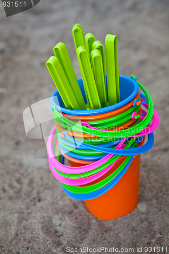 Image of Colourful buckets on a sandy beach