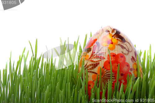 Image of Easter egg in the grass isolated on white 