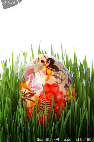 Image of Easter egg in the grass isolated on white 