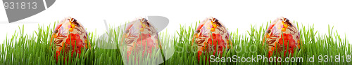 Image of Easter eggs in the grass isolated on white 