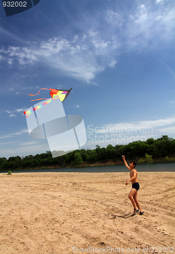 Image of boy running kite